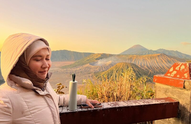 A guest watching the golden sunrise over the Bromo caldera