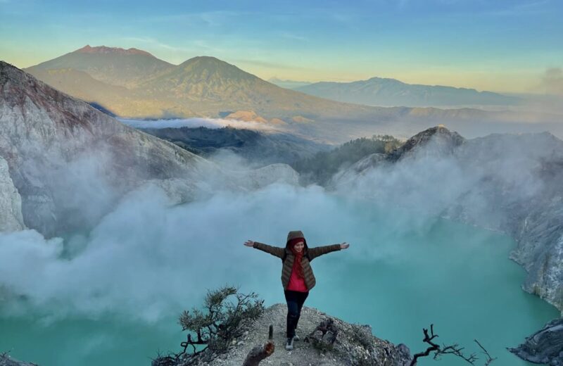 A guest on a ledge above the turquoise Ijen crater lake