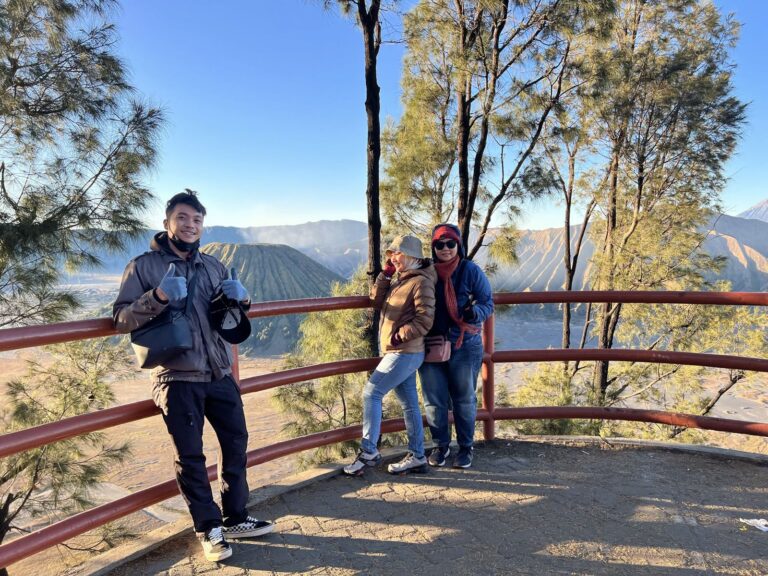 Guests at a railing viewpoint over the Tengger caldera