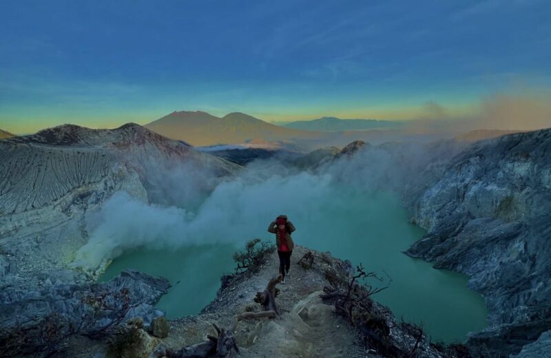 The turquoise crater lake seen from the rim at first light