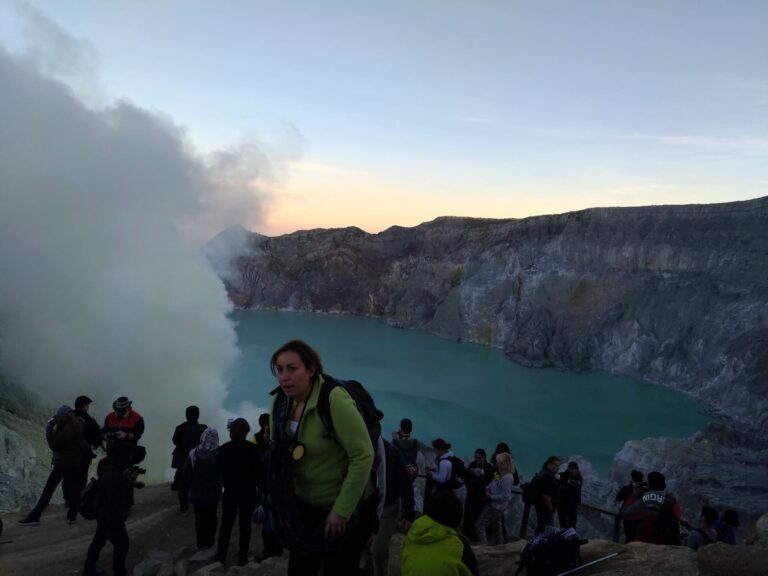 Hikers gathered at the Ijen crater rim at dawn