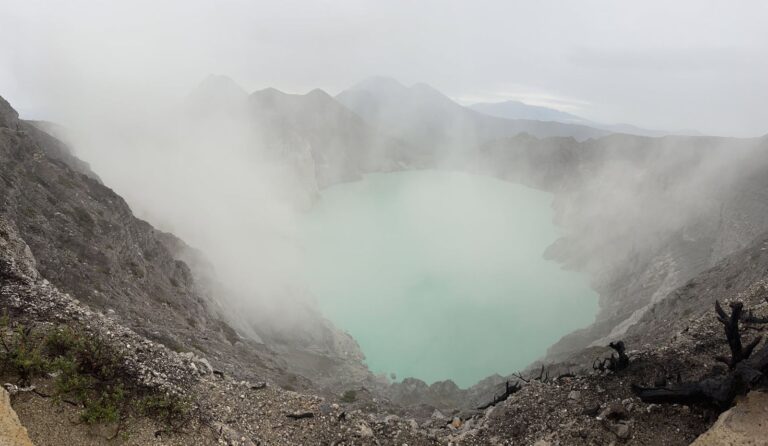 Turquoise Kawah Ijen lake in the morning mist