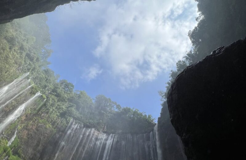 Looking up at Tumpak Sewu through an opening in the rocks